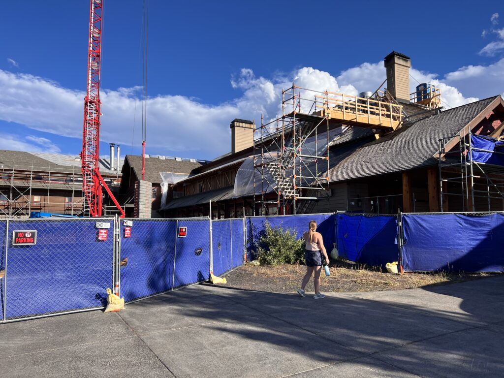 Walking past construction fencing and scaffolding at the Snow Lodge